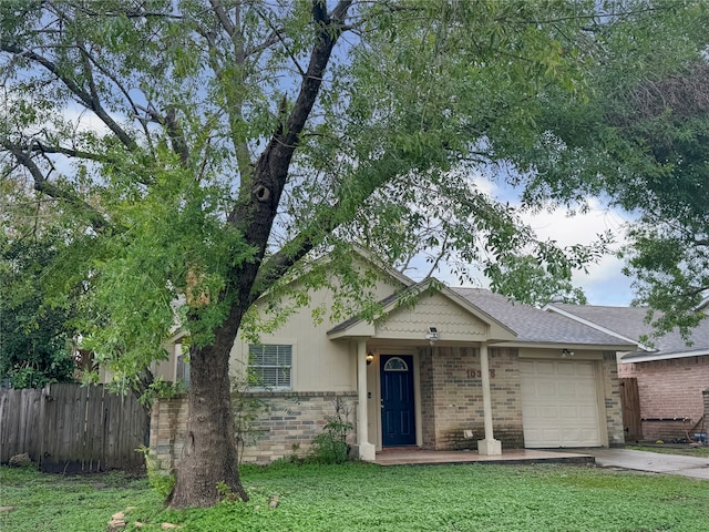 view of front facade featuring a garage and a front lawn