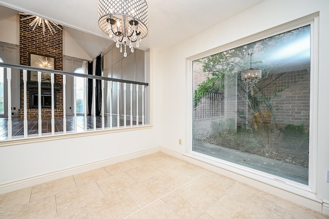 unfurnished dining area with tile patterned floors and a notable chandelier