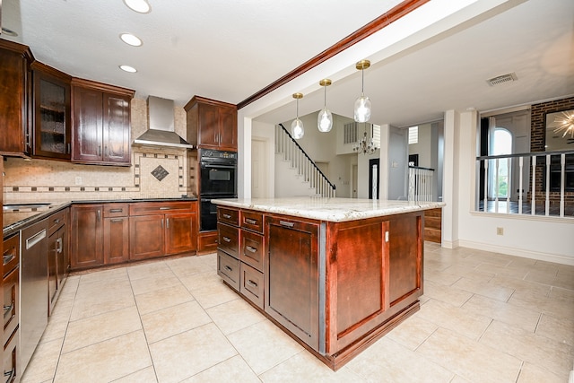 kitchen featuring hanging light fixtures, tasteful backsplash, a kitchen island, black appliances, and wall chimney range hood