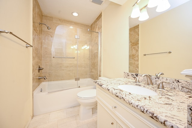 full bathroom featuring vanity, tiled shower / bath combo, toilet, and tile patterned floors