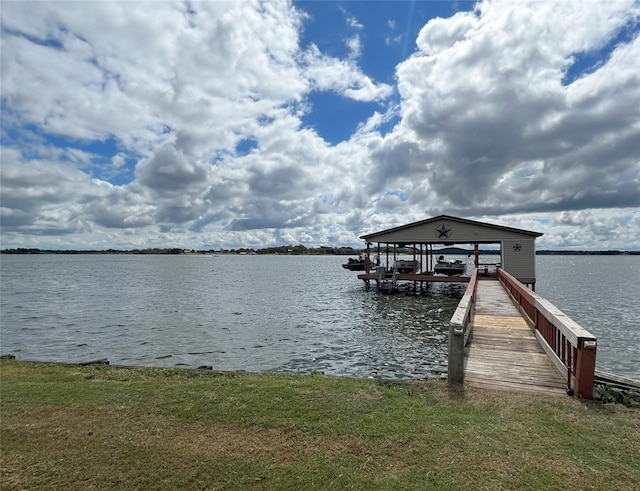 dock area featuring a lawn and a water view