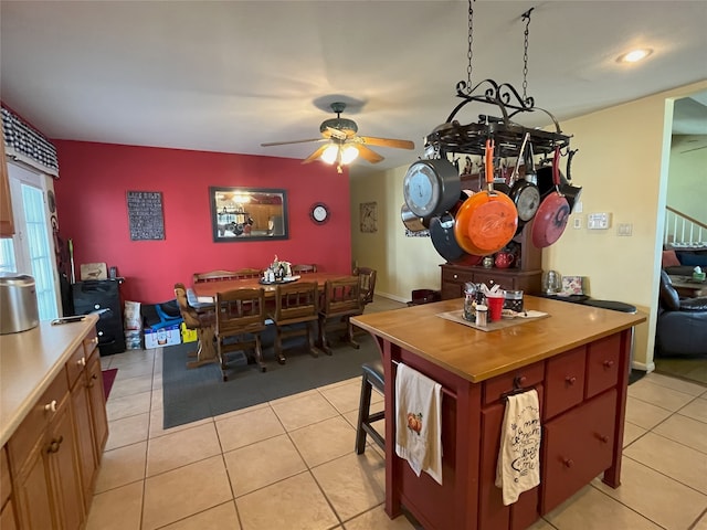 tiled dining space featuring ceiling fan