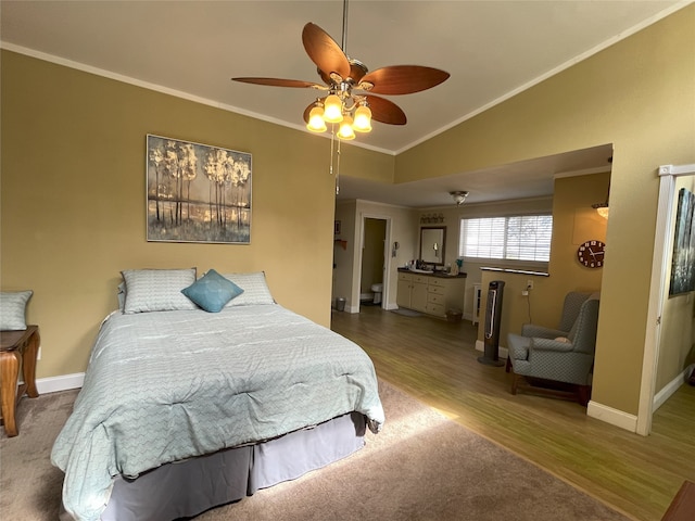 bedroom with wood-type flooring, vaulted ceiling, ceiling fan, and ornamental molding