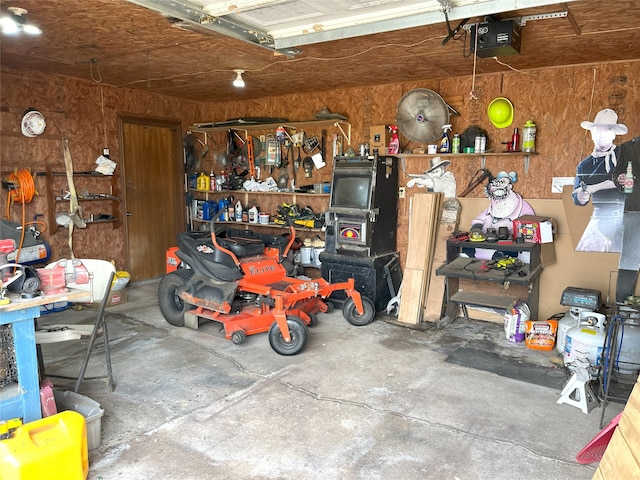 garage with a garage door opener and a workshop area