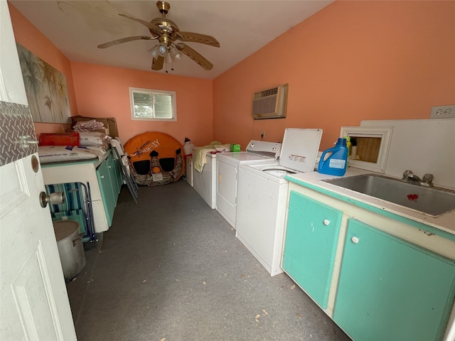 laundry area with washer and clothes dryer, a wall mounted air conditioner, sink, and ceiling fan