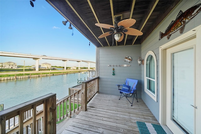 wooden terrace featuring a water view and ceiling fan