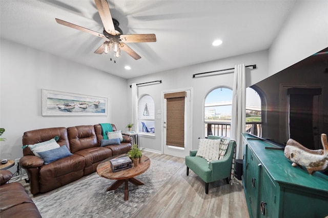 living room featuring light wood-type flooring and ceiling fan