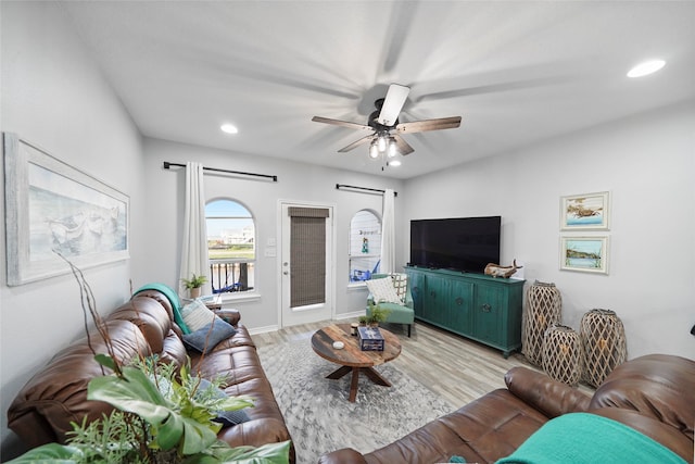 living room with ceiling fan and light wood-type flooring