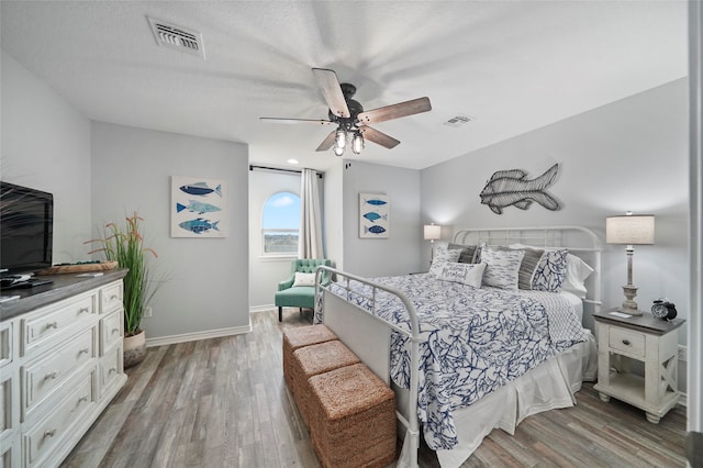 bedroom with ceiling fan and hardwood / wood-style flooring