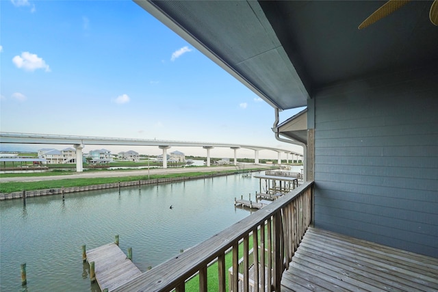 balcony with a boat dock and a water view