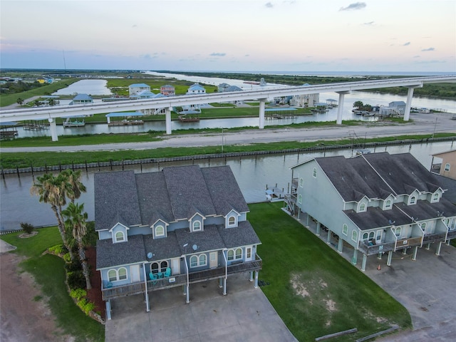 aerial view at dusk with a water view