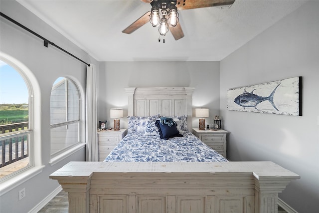 bedroom featuring multiple windows, light wood-type flooring, and ceiling fan