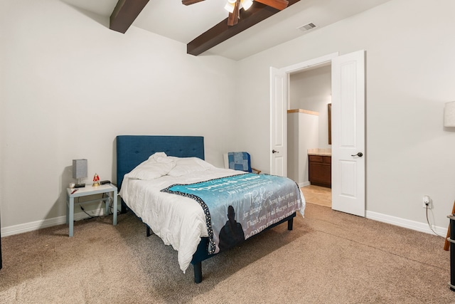 carpeted bedroom featuring connected bathroom, beam ceiling, and ceiling fan