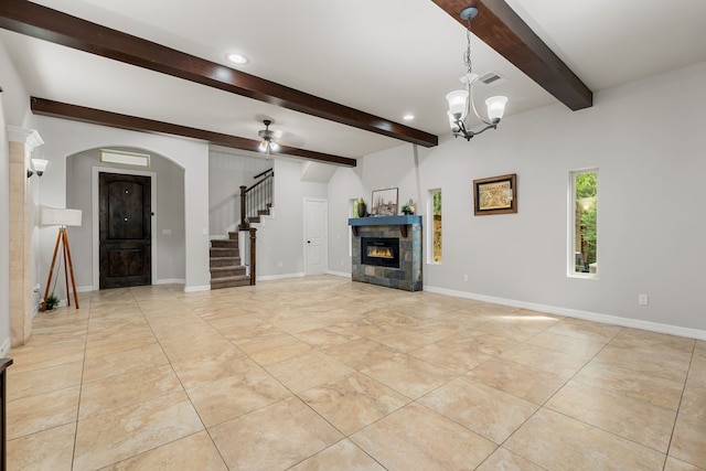 unfurnished living room featuring light tile patterned floors, ceiling fan with notable chandelier, beam ceiling, and a tile fireplace