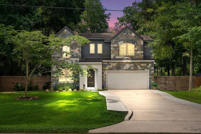 view of front of property featuring a yard and a garage