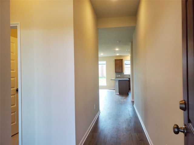 hallway with dark hardwood / wood-style flooring