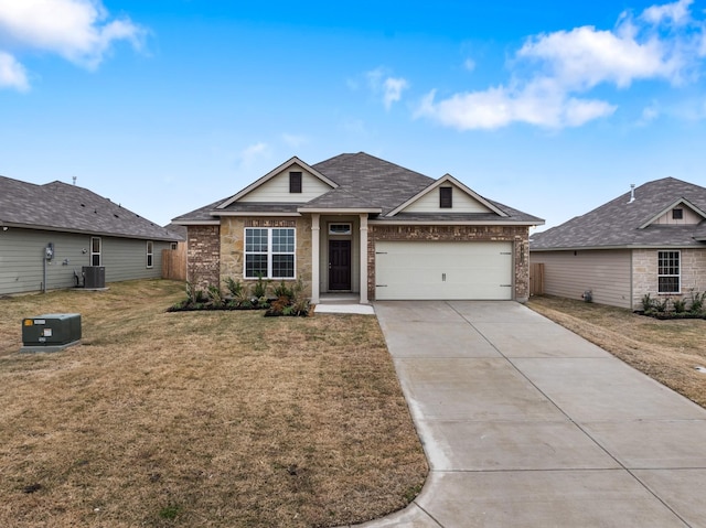 view of front of house with a garage, a front lawn, and central air condition unit