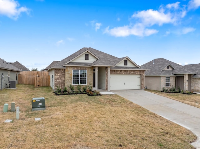 view of front of house featuring cooling unit, a garage, and a front lawn