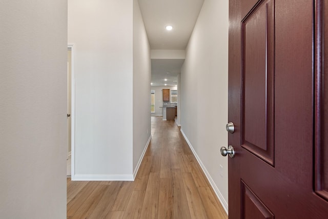 hallway with light hardwood / wood-style floors