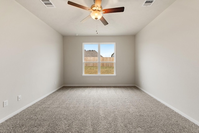 carpeted spare room featuring ceiling fan