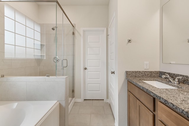 bathroom with tile patterned flooring, vanity, and independent shower and bath