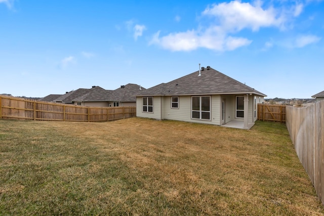 rear view of property with a patio area and a lawn