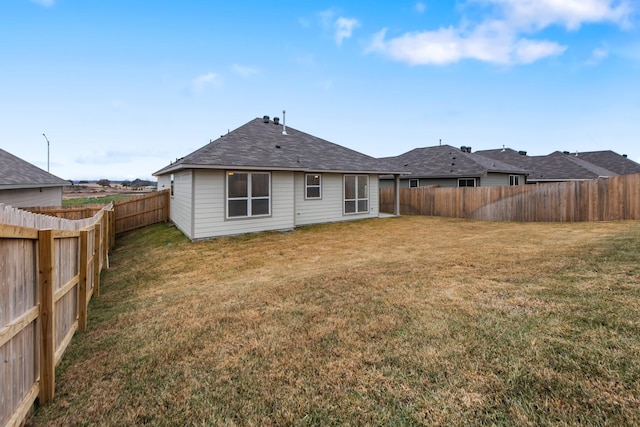 rear view of house with a lawn