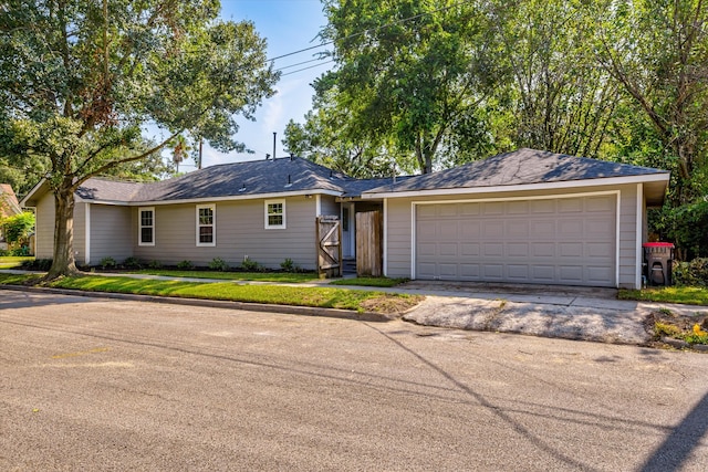 single story home featuring a garage and a front yard