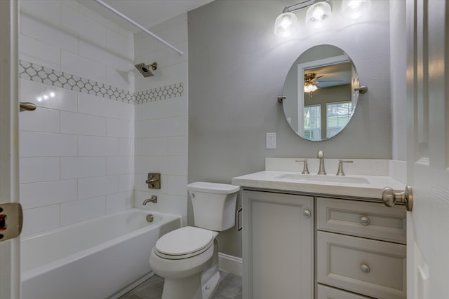 full bathroom featuring ceiling fan, vanity, tiled shower / bath combo, and toilet