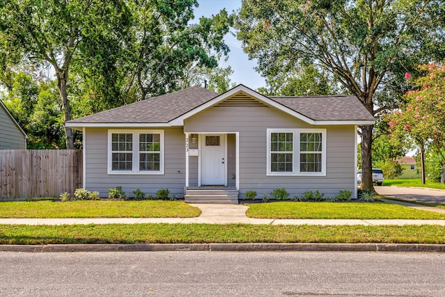 bungalow-style house featuring a front yard