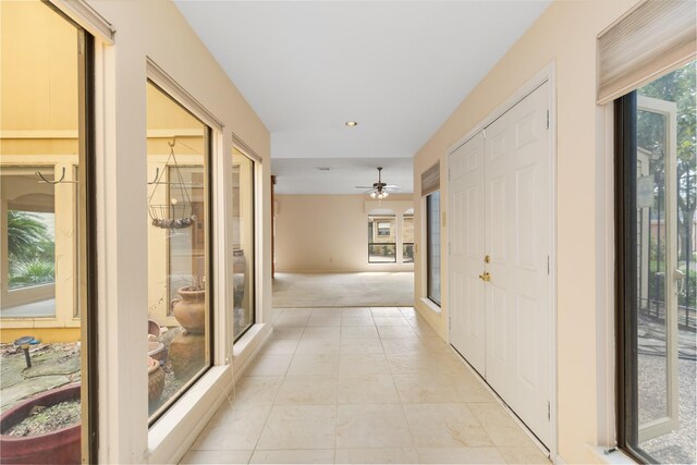 hallway featuring light colored carpet