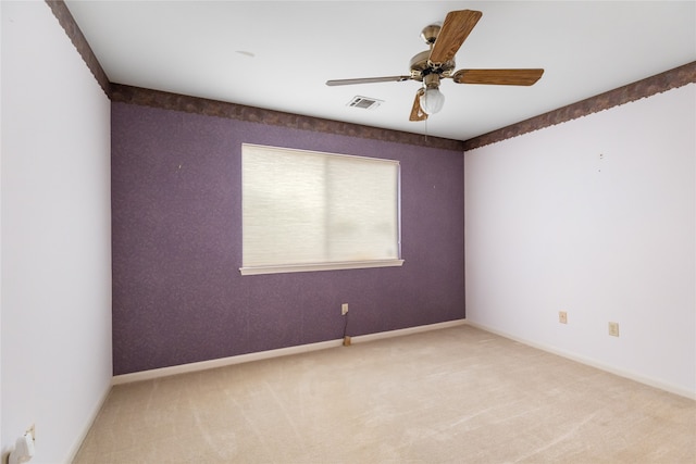 spare room with ceiling fan and carpet flooring