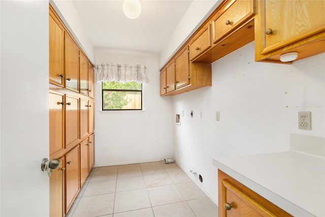 laundry room with washer hookup, light tile patterned floors, gas dryer hookup, cabinets, and electric dryer hookup