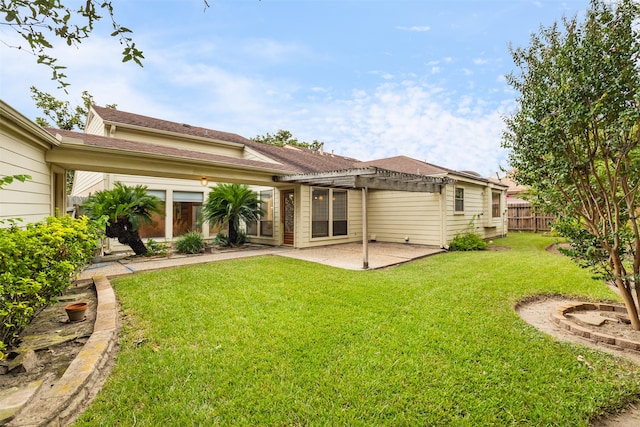 back of house with a pergola, a yard, and a patio area