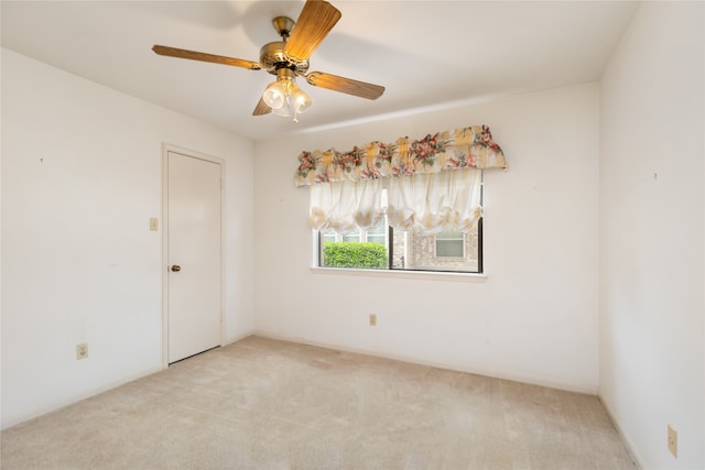 spare room with light carpet and ceiling fan