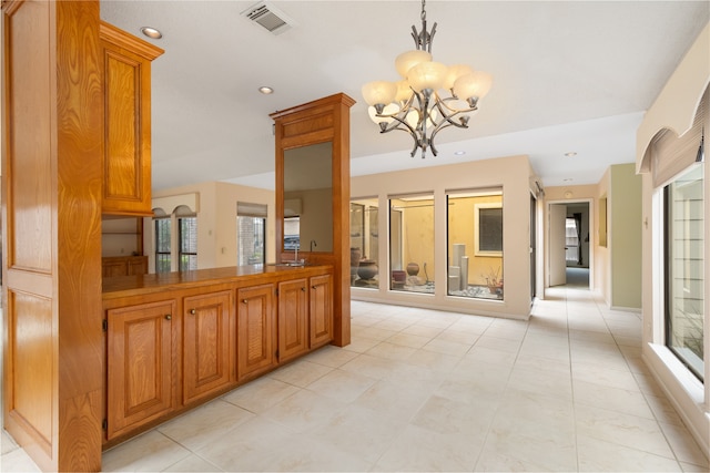 interior space with an inviting chandelier, sink, and light tile patterned floors