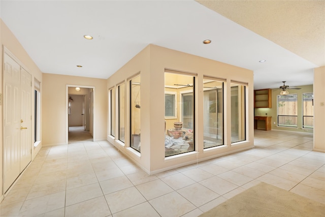 hall featuring light tile patterned floors