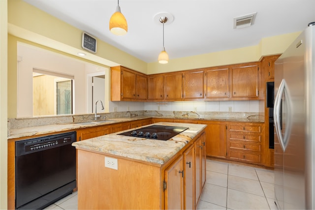 kitchen featuring light tile patterned flooring, pendant lighting, black appliances, a center island, and sink