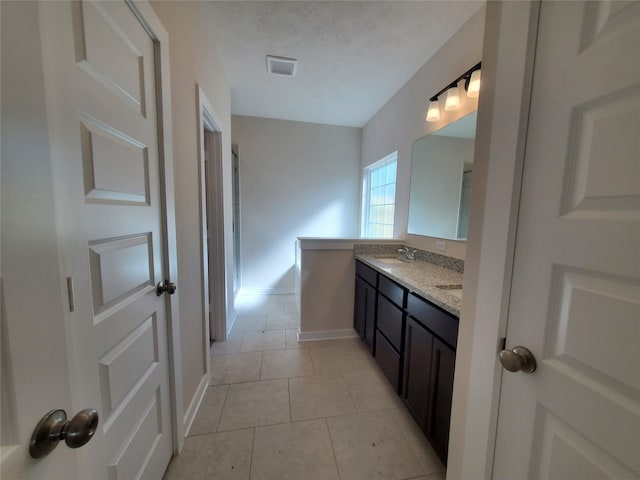 bathroom featuring tile patterned flooring and vanity