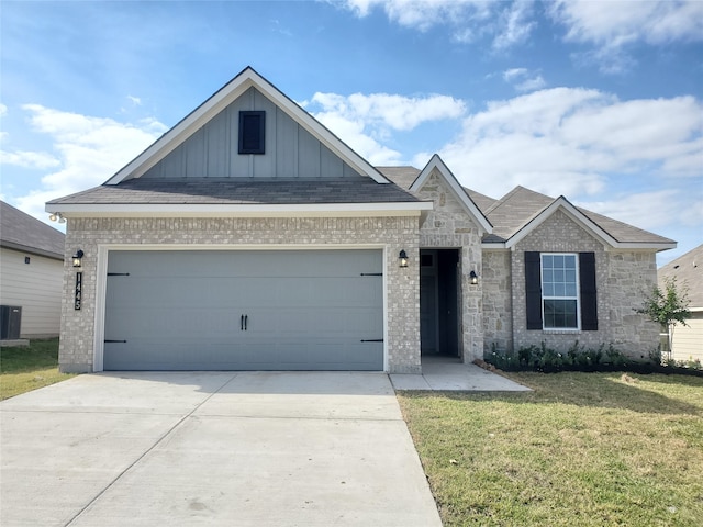 view of front of house featuring a garage and a front lawn