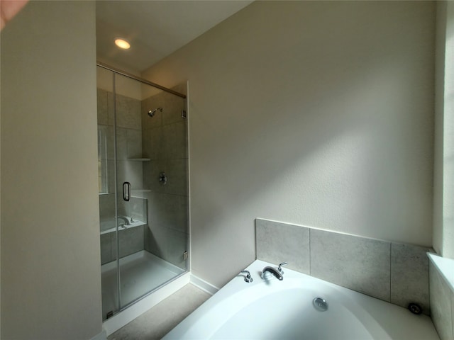 bathroom featuring separate shower and tub