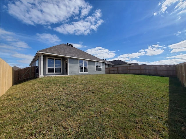 back of property featuring a yard