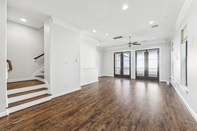 unfurnished living room with crown molding, dark hardwood / wood-style floors, ceiling fan, and french doors