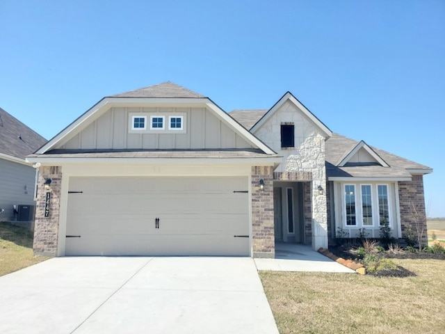 view of front of property featuring concrete driveway, stone siding, board and batten siding, and an attached garage