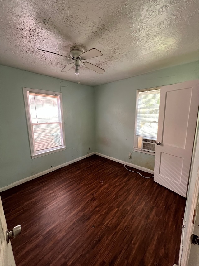 spare room with a textured ceiling, dark hardwood / wood-style flooring, and ceiling fan