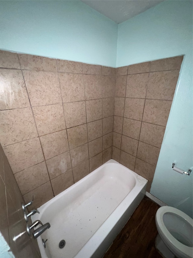 bathroom with shower with separate bathtub, hardwood / wood-style flooring, and toilet