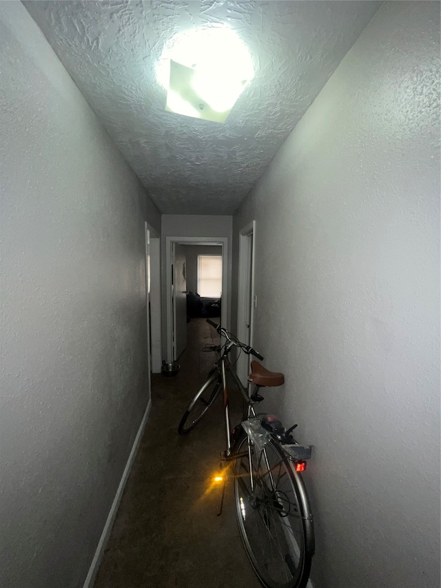 hallway with a textured ceiling