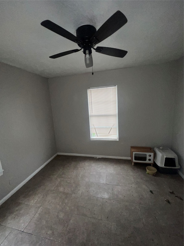 spare room with ceiling fan and a textured ceiling