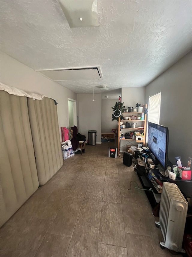 miscellaneous room with wood-type flooring and a textured ceiling