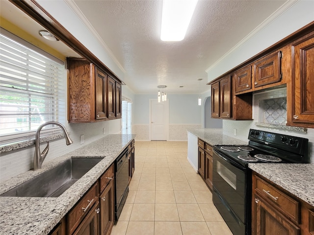 kitchen featuring light stone counters, a textured ceiling, sink, black appliances, and crown molding